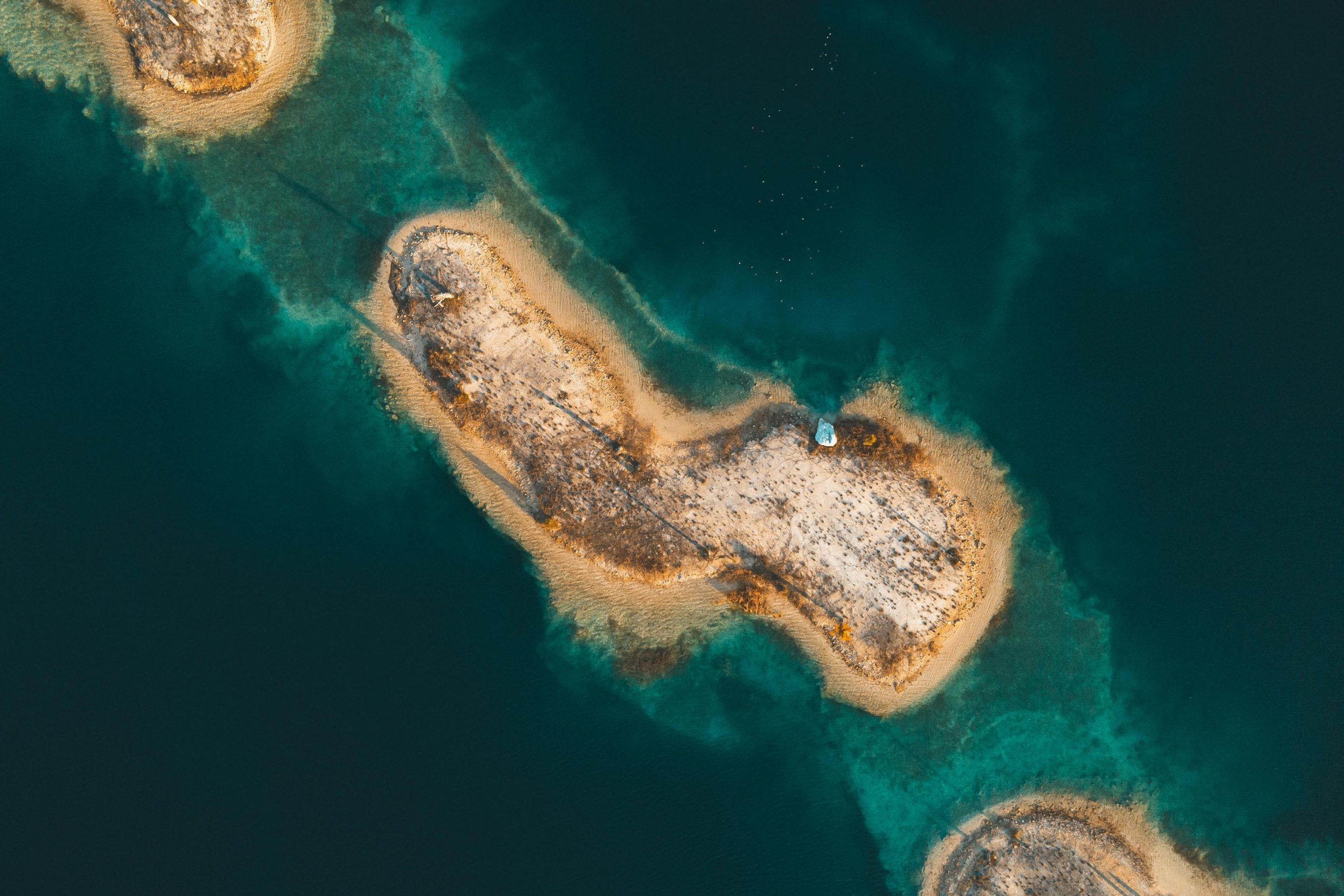 A breathtaking aerial shot of sandy islands surrounded by turquoise waters in Florida.